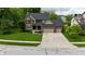 Stunning two-story home featuring a well-manicured lawn and a spacious three-car garage and brick exterior at 3251 Amber Way, Bargersville, IN 46106