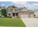 Charming brick home boasts a well-manicured lawn and three-car garage at 3251 Amber Way, Bargersville, IN 46106