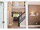 Bright foyer with hardwood floors, elegant staircase, and view into the open-concept living space at 3251 Amber Way, Bargersville, IN 46106