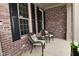 Charming front porch with brick exterior and cozy seating area, perfect for relaxing outdoors at 3251 Amber Way, Bargersville, IN 46106
