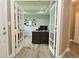 Stylish home office with double doors, a modern desk, and a cozy red sofa for relaxation at 3251 Amber Way, Bargersville, IN 46106