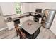 Bright kitchen with stainless steel appliances, granite counters, white cabinetry, and a functional center island at 3251 Amber Way, Bargersville, IN 46106