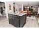Spacious kitchen featuring a dark kitchen island with granite countertop and seating for casual dining at 3251 Amber Way, Bargersville, IN 46106