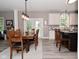 Open dining and kitchen layout featuring neutral decor, breakfast bar, and modern lighting at 3251 Amber Way, Bargersville, IN 46106