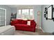 Cozy living room featuring a comfortable red couch, large window, and decor at 3251 Amber Way, Bargersville, IN 46106