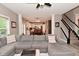 Spacious living room showcases a sectional sofa, leading to a modern kitchen and staircase at 3251 Amber Way, Bargersville, IN 46106