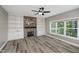 Cozy living room with stone fireplace, built-in bookshelves, and large window at 3251 Amber Way, Bargersville, IN 46106