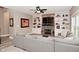 Comfortable living room with a stone fireplace, built-in shelving, and a large gray sectional sofa at 3251 Amber Way, Bargersville, IN 46106