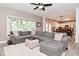 Bright living room featuring a large sectional sofa, soft rug, and a view of the kitchen and dining areas at 3251 Amber Way, Bargersville, IN 46106