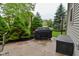 Patio area with a covered grill, storage bench, and lush landscaped garden at 3251 Amber Way, Bargersville, IN 46106