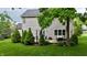 Inviting outdoor patio area with comfortable seating, lush landscaping, and a tranquil backyard setting at 3251 Amber Way, Bargersville, IN 46106