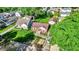 Aerial view of a brick home showcasing its backyard, driveway, and surrounding lush greenery at 3310 Ransdell St, Indianapolis, IN 46227