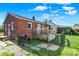 Brick house featuring a backyard with chainlink fence, grill, and steps up to the deck at 3310 Ransdell St, Indianapolis, IN 46227