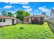 Brick home featuring a large backyard, wooden deck with steps, and a shed at 3310 Ransdell St, Indianapolis, IN 46227