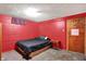 View of a cozy bedroom with red walls and a comfortable-looking bed at 3310 Ransdell St, Indianapolis, IN 46227