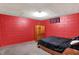 View of a bedroom with red walls, a bed, and a wooden dresser at 3310 Ransdell St, Indianapolis, IN 46227