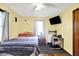 Inviting bedroom with natural light, comfortable bed, desk, and TV, perfect for relaxation at 3310 Ransdell St, Indianapolis, IN 46227