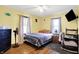 Bright bedroom with hardwood floors, fan, a comfortable bed, and a functional workspace at 3310 Ransdell St, Indianapolis, IN 46227