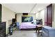 Bright bedroom featuring sunflower art, a bed and a tv on a stand at 3310 Ransdell St, Indianapolis, IN 46227