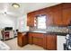 Traditional kitchen featuring wooden cabinets, a tiled backsplash, and practical appliances at 3310 Ransdell St, Indianapolis, IN 46227