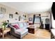 Spacious living room with hardwood floors, a comfortable gray sectional sofa, and large windows at 3310 Ransdell St, Indianapolis, IN 46227