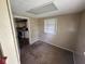 Bedroom with carpet, closet, and window offering natural light and glimpse of kitchen at 3403 Coffey St, Indianapolis, IN 46217