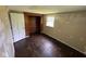 Bedroom featuring hardwood floors, a window for natural light, and a closet at 3403 Coffey St, Indianapolis, IN 46217
