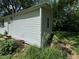 Exterior corner of a house with white siding surrounded by plants and greenery at 3403 Coffey St, Indianapolis, IN 46217