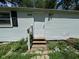 Front entrance of home with white door, brick pathway, and lush garden at 3403 Coffey St, Indianapolis, IN 46217