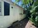 The home's side entrance featuring a white door, black shutters, and vinyl siding at 3403 Coffey St, Indianapolis, IN 46217