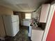 View of kitchen featuring white cabinets and appliances, and vinyl flooring at 3403 Coffey St, Indianapolis, IN 46217