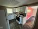 View of kitchen featuring white cabinets and appliances, and vinyl flooring at 3403 Coffey St, Indianapolis, IN 46217