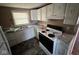 Classic kitchen featuring white cabinets, light countertops, and a stainless-steel sink at 3403 Coffey St, Indianapolis, IN 46217