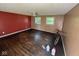 View of living room showcasing hardwood floors, ceiling fan, and windows at 3403 Coffey St, Indianapolis, IN 46217