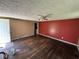 View of living room showcasing hardwood floors, ceiling fan, and interior doorway at 3403 Coffey St, Indianapolis, IN 46217