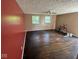 View of living room showcasing hardwood floors, ceiling fan, and windows at 3403 Coffey St, Indianapolis, IN 46217