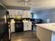 Bright kitchen featuring white cabinets and modern appliances, with an adjacent seating area at 3417 N Sadlier Dr, Indianapolis, IN 46226