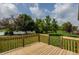 View from wooden deck of lush backyard, mature trees and scenic pond at 3419 Burlingame Blvd, Carmel, IN 46074