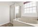 Bathroom featuring a jacuzzi tub with marble countertop, a shower stall, and a window at 3419 Burlingame Blvd, Carmel, IN 46074