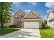 Beautiful two-story brick home with manicured lawn, two-car garage, and blue skies at 3419 Burlingame Blvd, Carmel, IN 46074