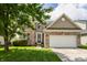 Charming two-story brick home with a well-manicured lawn and attached two-car garage at 3419 Burlingame Blvd, Carmel, IN 46074