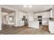 Modern kitchen featuring white cabinetry, stainless steel appliances, and wood-look flooring at 3419 Burlingame Blvd, Carmel, IN 46074