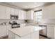 Bright kitchen with white cabinets, stainless steel appliances, and a center island with white countertop at 3419 Burlingame Blvd, Carmel, IN 46074