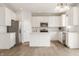 Contemporary kitchen showcasing sleek white cabinets, stainless steel appliances, and ample counter space at 3419 Burlingame Blvd, Carmel, IN 46074