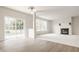 Bright living room with fireplace, large windows, and sliding doors leading to outdoor space at 3419 Burlingame Blvd, Carmel, IN 46074