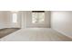 Bright living room featuring carpet, a large window, and an open floor plan at 3419 Burlingame Blvd, Carmel, IN 46074