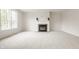 Living room featuring a fireplace, large window, and neutral carpeting at 3419 Burlingame Blvd, Carmel, IN 46074