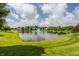 Scenic community pond with a fountain, surrounded by lush green lawns and trees at 3419 Burlingame Blvd, Carmel, IN 46074