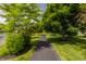 Community walking path near water with lush green landscaping and trees at 3419 Burlingame Blvd, Carmel, IN 46074
