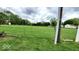 Expansive backyard with lush green grass, secured by chain-link fencing for privacy at 3702 Candy Cane Dr, Indianapolis, IN 46227